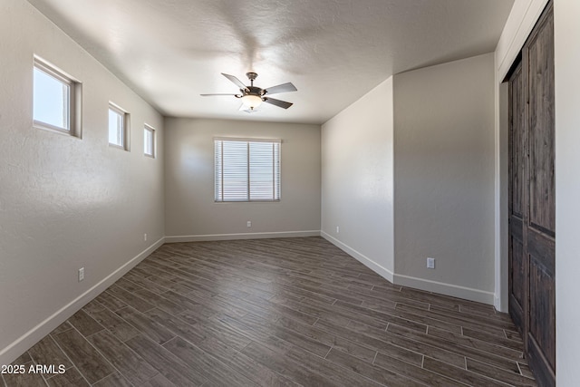6397 E Red Oak Cir, Hereford, AZ 85615 - spare room featuring baseboards, a ceiling fan, and dark wood-style floors