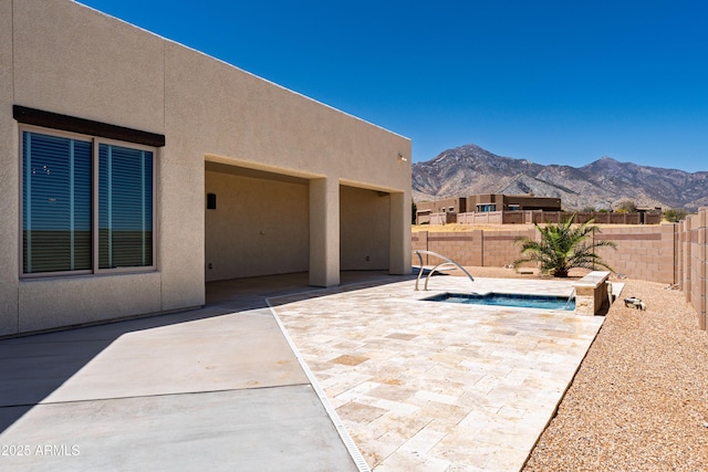 6397 E Red Oak Cir, Hereford, AZ 85615 - view of patio / terrace with a fenced backyard, a mountain view, and an in ground hot tub