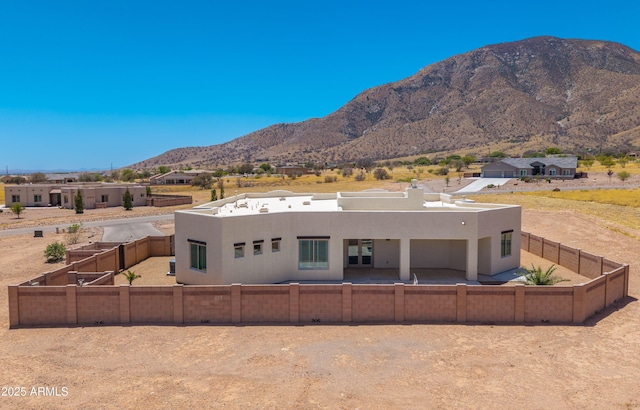 6397 E Red Oak Cir, Hereford, AZ 85615 - rear view of property with a fenced backyard, a mountain view, and stucco siding