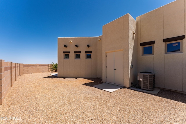 6397 E Red Oak Cir, Hereford, AZ 85615 - view of property exterior with fence, central AC unit, and stucco siding