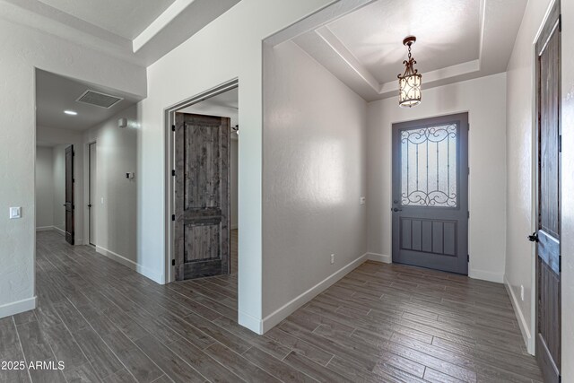 6397 E Red Oak Cir, Hereford, AZ 85615 - entrance foyer with an inviting chandelier, dark wood finished floors, baseboards, a tray ceiling, and visible vents