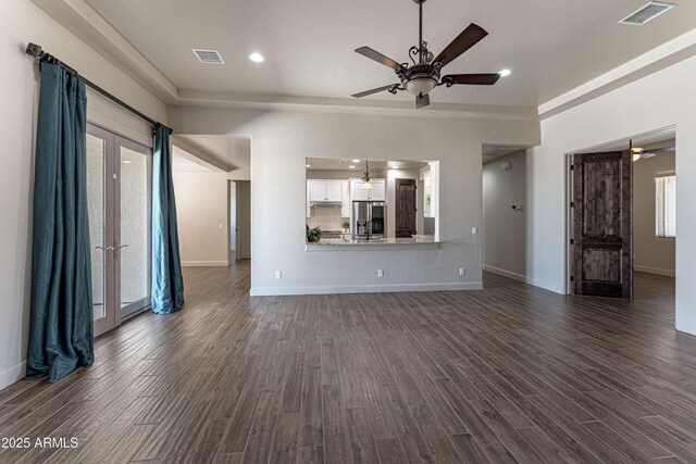 6397 E Red Oak Cir, Hereford, AZ 85615 - unfurnished living room with visible vents, a ceiling fan, baseboards, and dark wood-style floors