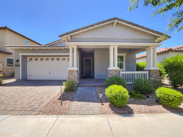 10559 E Simone Ave, Mesa, AZ 85212 - craftsman house with a garage, stucco siding, covered porch, decorative driveway, and stone siding