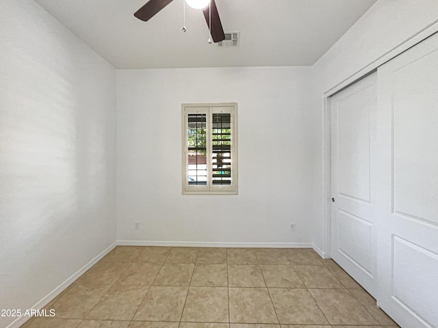 10559 E Simone Ave, Mesa, AZ 85212 - unfurnished bedroom with light tile patterned floors, a closet, and a ceiling fan