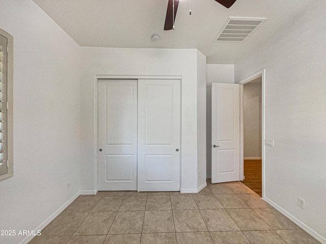 10559 E Simone Ave, Mesa, AZ 85212 - unfurnished bedroom with light tile patterned floors, a closet, and ceiling fan