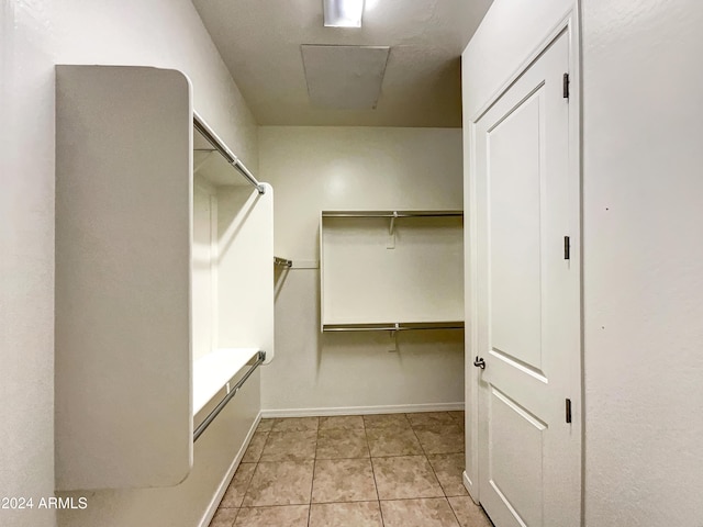 spacious closet featuring light tile patterned floors