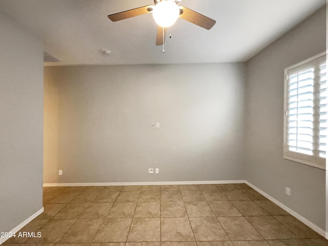 empty room with light tile patterned floors and ceiling fan