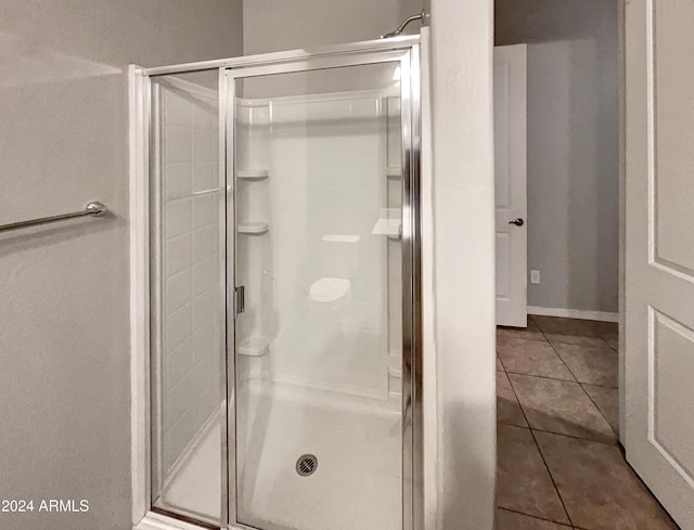 bathroom with tile patterned flooring and walk in shower