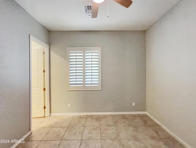 unfurnished room featuring light tile patterned floors and ceiling fan