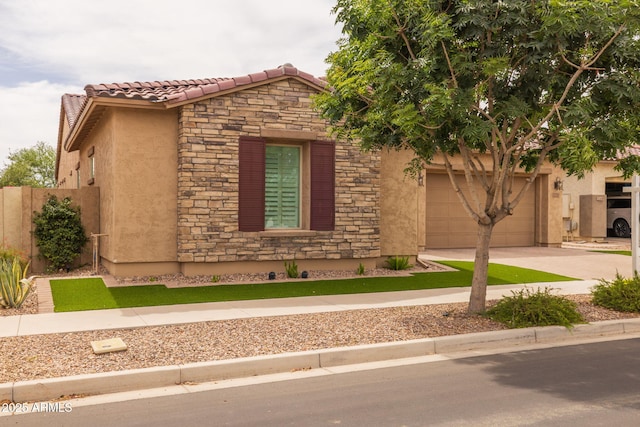 5250 S Wesley Cir, Mesa, AZ 85212 - view of front of property featuring stone siding, stucco siding, driveway, an attached garage, and a tile roof