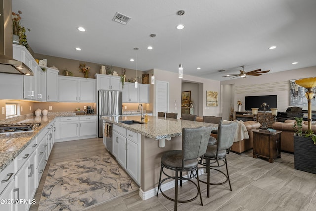 5250 S Wesley Cir, Mesa, AZ 85212 - kitchen featuring a sink, appliances with stainless steel finishes, wall chimney range hood, white cabinets, and recessed lighting