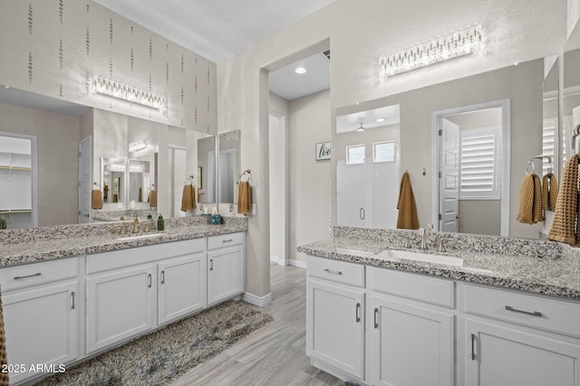 5250 S Wesley Cir, Mesa, AZ 85212 - bathroom with two vanities, baseboards, and wood finished floors