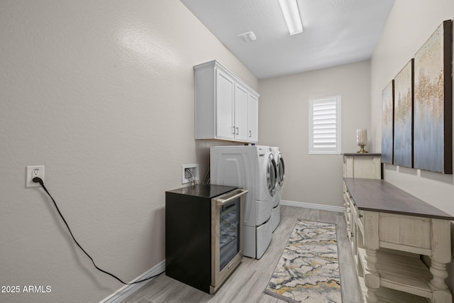 5250 S Wesley Cir, Mesa, AZ 85212 - laundry room with washing machine and dryer, cabinet space, light wood-type flooring, and baseboards