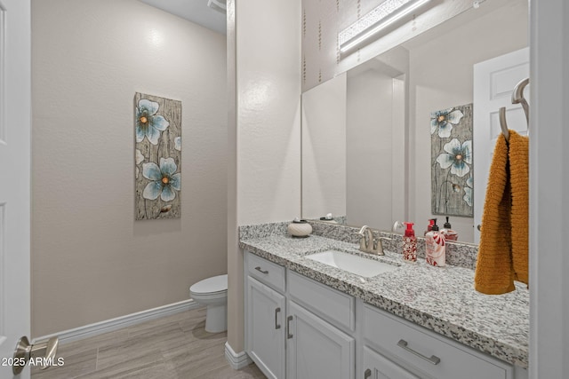 5250 S Wesley Cir, Mesa, AZ 85212 - bathroom with vanity, toilet, baseboards, and wood finished floors