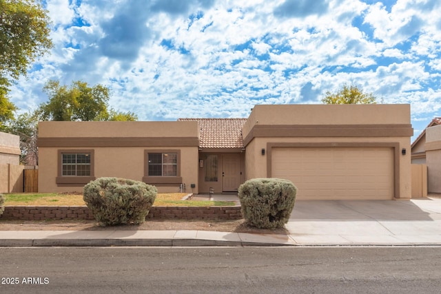 pueblo-style house with a garage