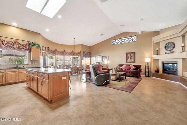 living room featuring a notable chandelier and high vaulted ceiling