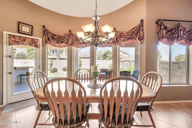 kitchen with light stone counters, sink, a kitchen island, high vaulted ceiling, and decorative light fixtures