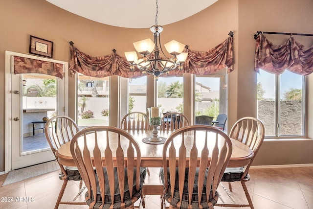 tiled dining space with an inviting chandelier and a healthy amount of sunlight