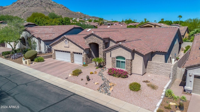 view of front of home with a garage and a mountain view