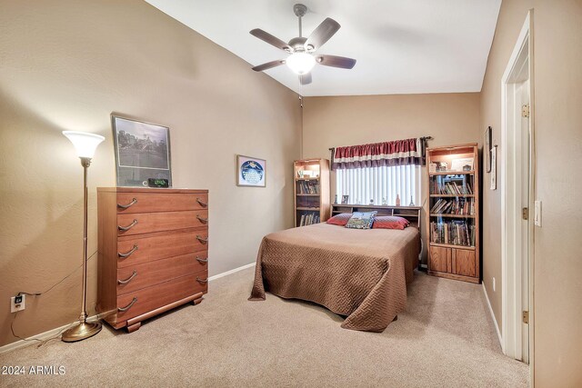 carpeted bedroom with ceiling fan and lofted ceiling