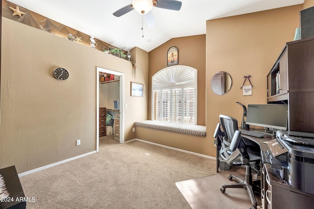 carpeted home office featuring vaulted ceiling and ceiling fan