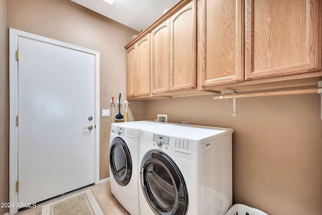 washroom featuring washing machine and dryer and cabinets