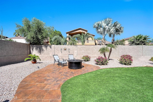 view of yard featuring a patio area and an outdoor fire pit