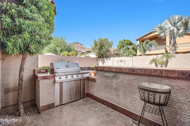 view of patio featuring area for grilling and exterior kitchen