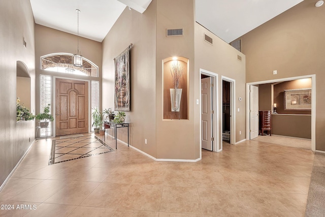 foyer entrance featuring high vaulted ceiling