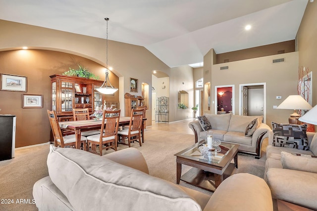 living room featuring light carpet and high vaulted ceiling