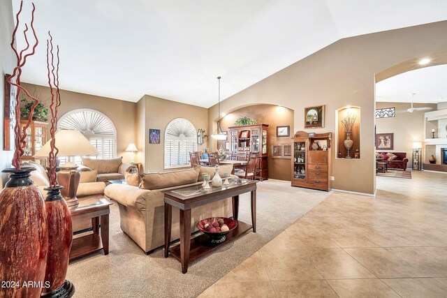 carpeted dining area featuring high vaulted ceiling and wine cooler