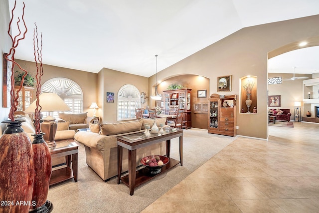 living room with lofted ceiling and light tile patterned floors