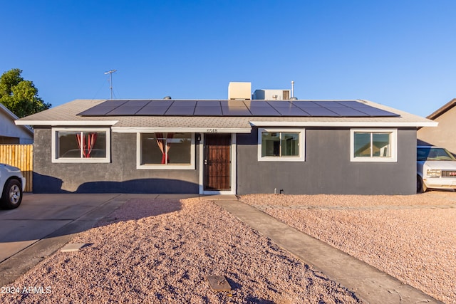 view of front of property with solar panels