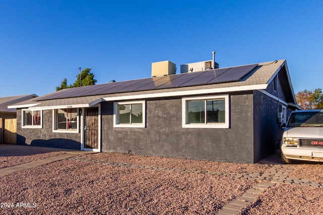 ranch-style home with solar panels