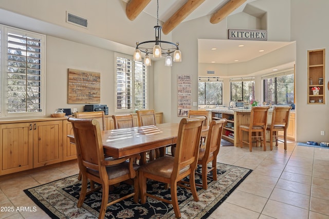 tiled dining room featuring beam ceiling, high vaulted ceiling, and a notable chandelier