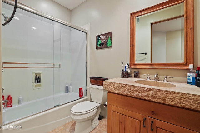 full bathroom featuring tile patterned flooring, vanity, toilet, and bath / shower combo with glass door