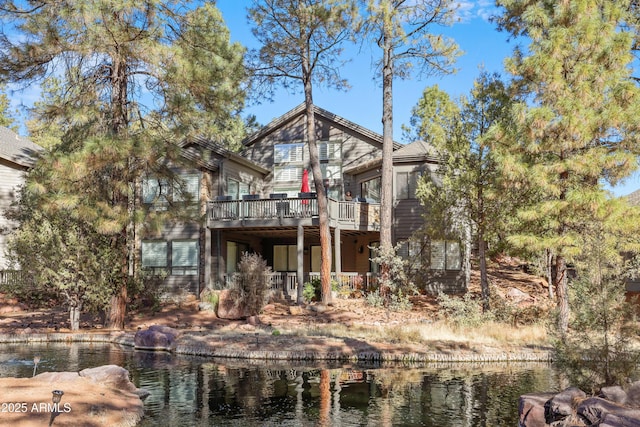 back of house with a deck with water view