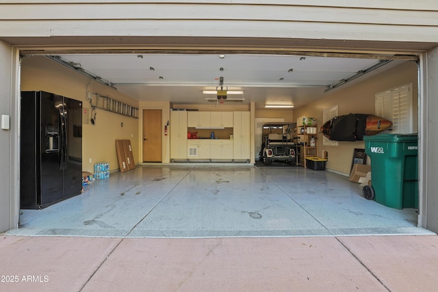 garage with black refrigerator with ice dispenser