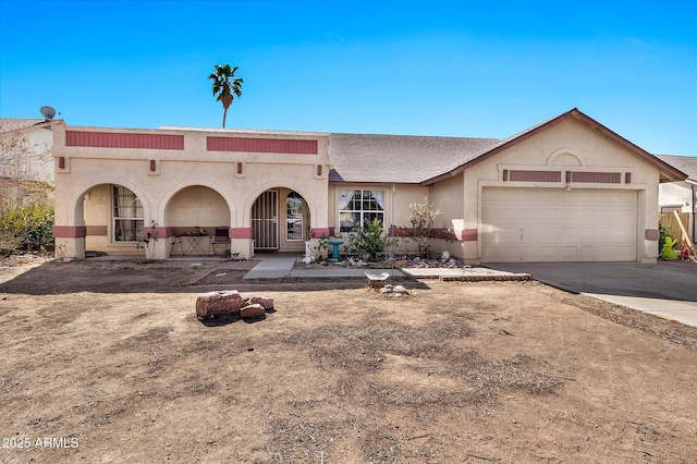 view of front of property featuring a garage, driveway, and stucco siding