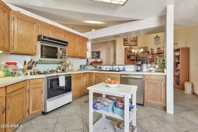 kitchen featuring tile countertops, white range with electric cooktop, light tile patterned flooring, a sink, and stainless steel dishwasher