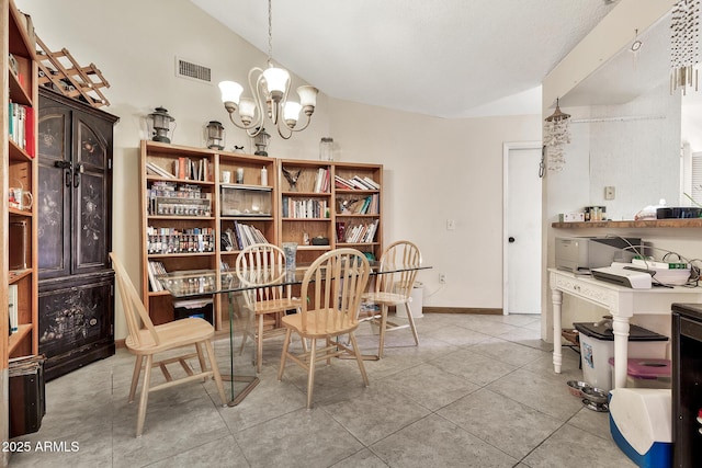 dining area featuring tile patterned floors, visible vents, baseboards, an inviting chandelier, and lofted ceiling