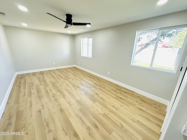 spare room featuring visible vents, a ceiling fan, recessed lighting, light wood finished floors, and baseboards