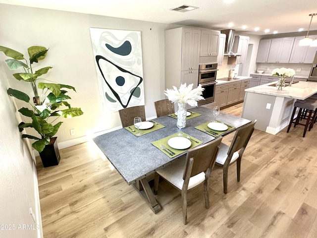 dining room with recessed lighting, visible vents, baseboards, and light wood-style floors