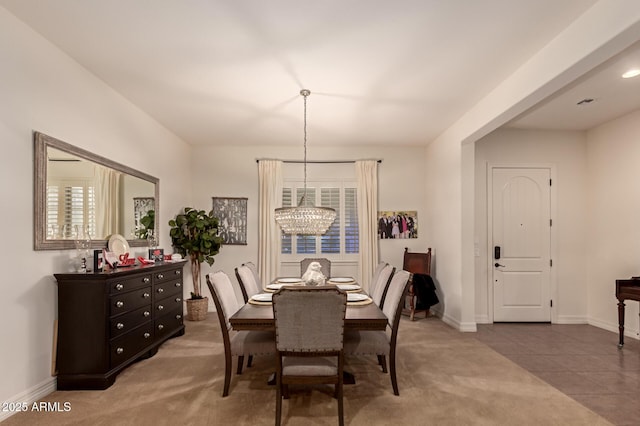 dining room featuring a notable chandelier and tile patterned floors