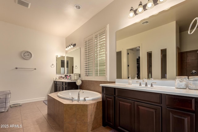 bathroom featuring tile patterned flooring, shower with separate bathtub, and vanity