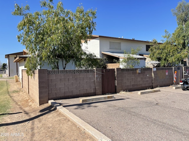 7109 W Wolf St, Phoenix, AZ 85033 - obstructed view of property featuring uncovered parking and a gate