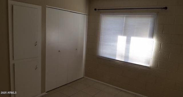 7109 W Wolf St, Phoenix, AZ 85033 - unfurnished bedroom with light tile patterned flooring and a closet