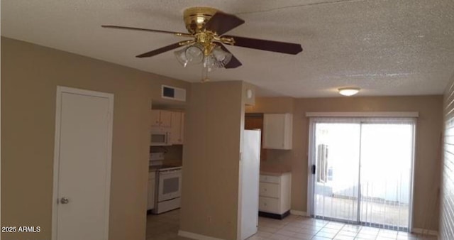 7109 W Wolf St, Phoenix, AZ 85033 - kitchen featuring white appliances, a ceiling fan, white cabinetry, light tile patterned floors, and baseboards