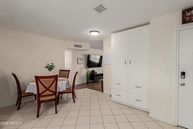 dining area featuring visible vents, baseboards, and light tile patterned floors