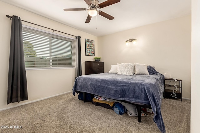 carpeted bedroom with ceiling fan and baseboards